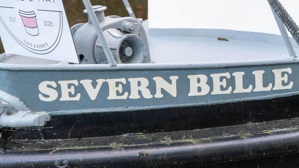 Close-up of the bow of a light-blue boat displaying SEVERN BELLE
