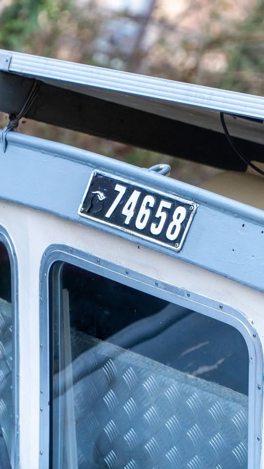 Close-up of the upper cabin of a light blue boat with license plate 74658